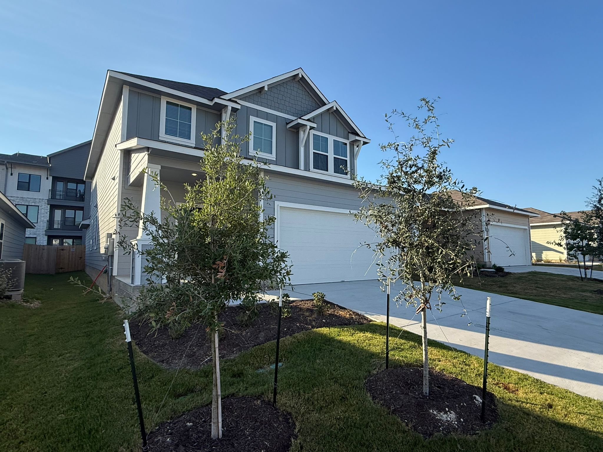 13308 Riding Drive Manor, TX 78653 - Photo 2 of 40 Craftsman house featuring board and batten siding, driveway, and an attached garage