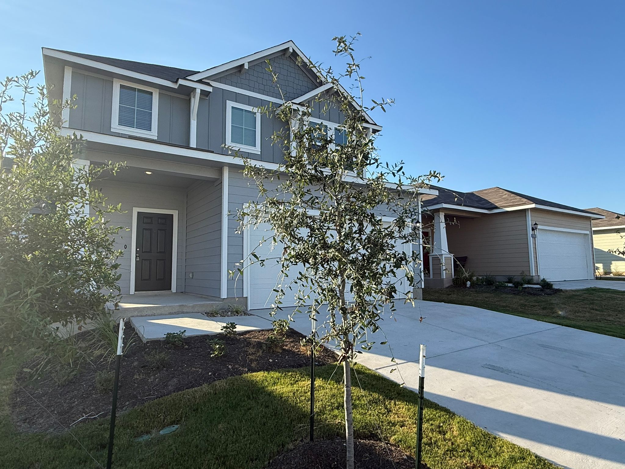 13308 Riding Drive Manor, TX 78653 - Photo 4 of 40 Craftsman-style house with driveway, a garage, and board and batten siding
