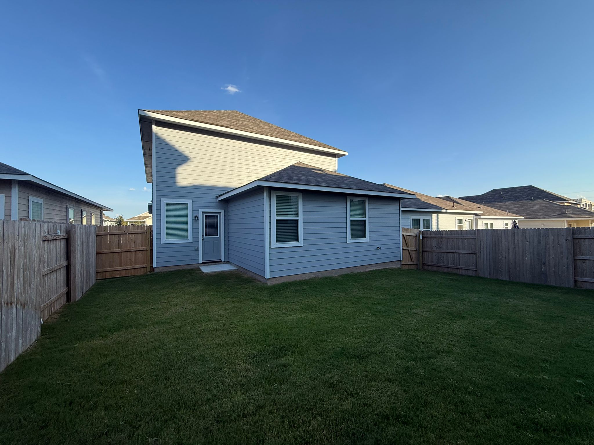 13308 Riding Drive Manor, TX 78653 - Photo 6 of 40 Rear view of house with a fenced backyard
