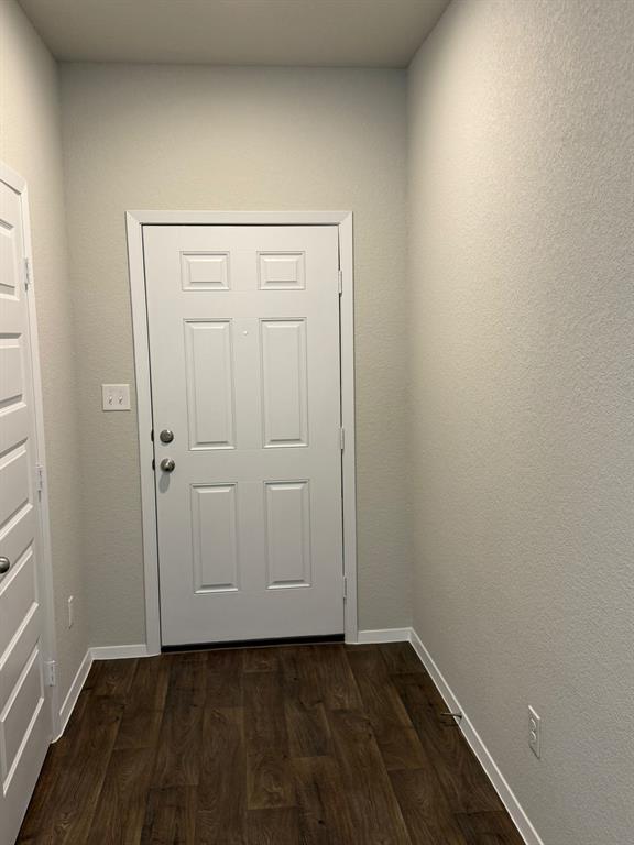 13308 Riding Drive Manor, TX 78653 - Photo 8 of 40 Doorway to outside featuring wood finished floors and baseboards