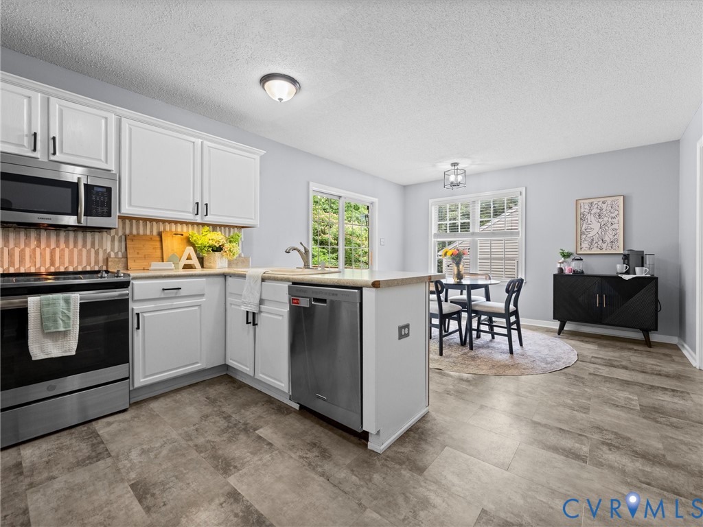 6712 Hedges Road Richmond, VA 23224 - Photo 27 of 34 Open-concept kitchen and dining area featuring whi