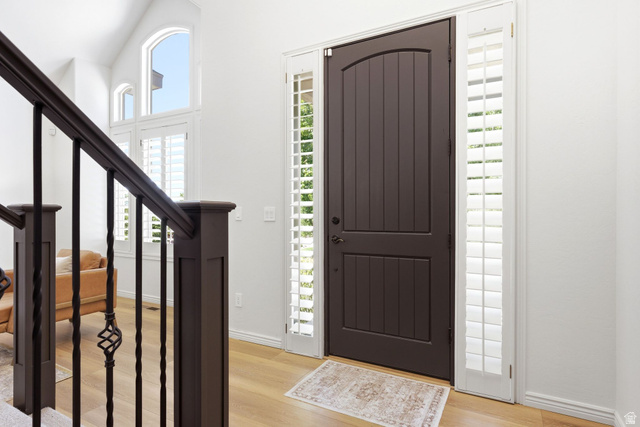 1712 Somerset Ridge Drive Draper, UT 84020 - Photo 5 of 76 Entryway featuring a dark wood-finish arched door, flanking sidelights with plantation shutters, and wood-finish flooring