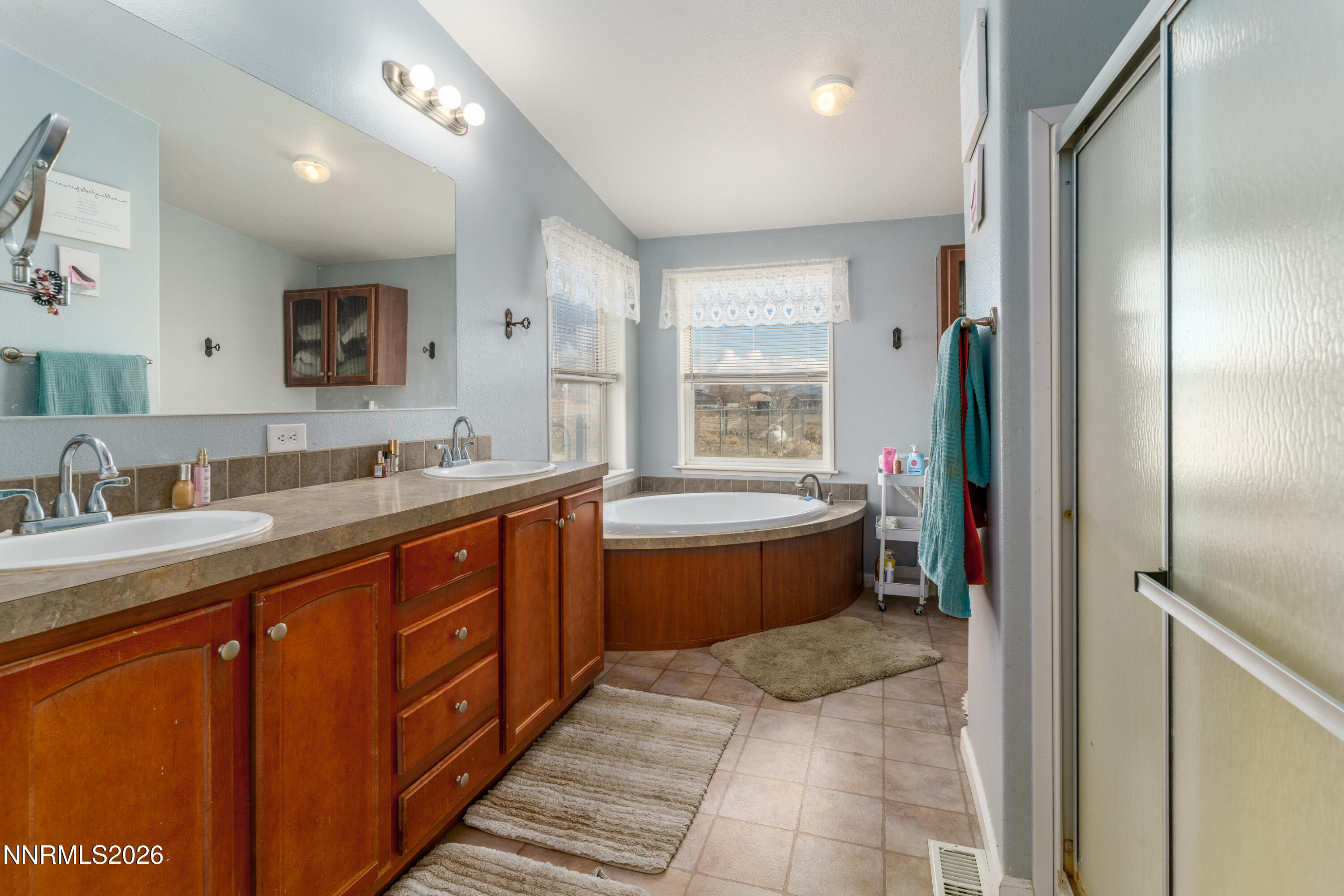 222 Julie Way Dayton, NV 89403 - Photo 16 of 28 a spacious bathroom with a tub sink shower and mirror