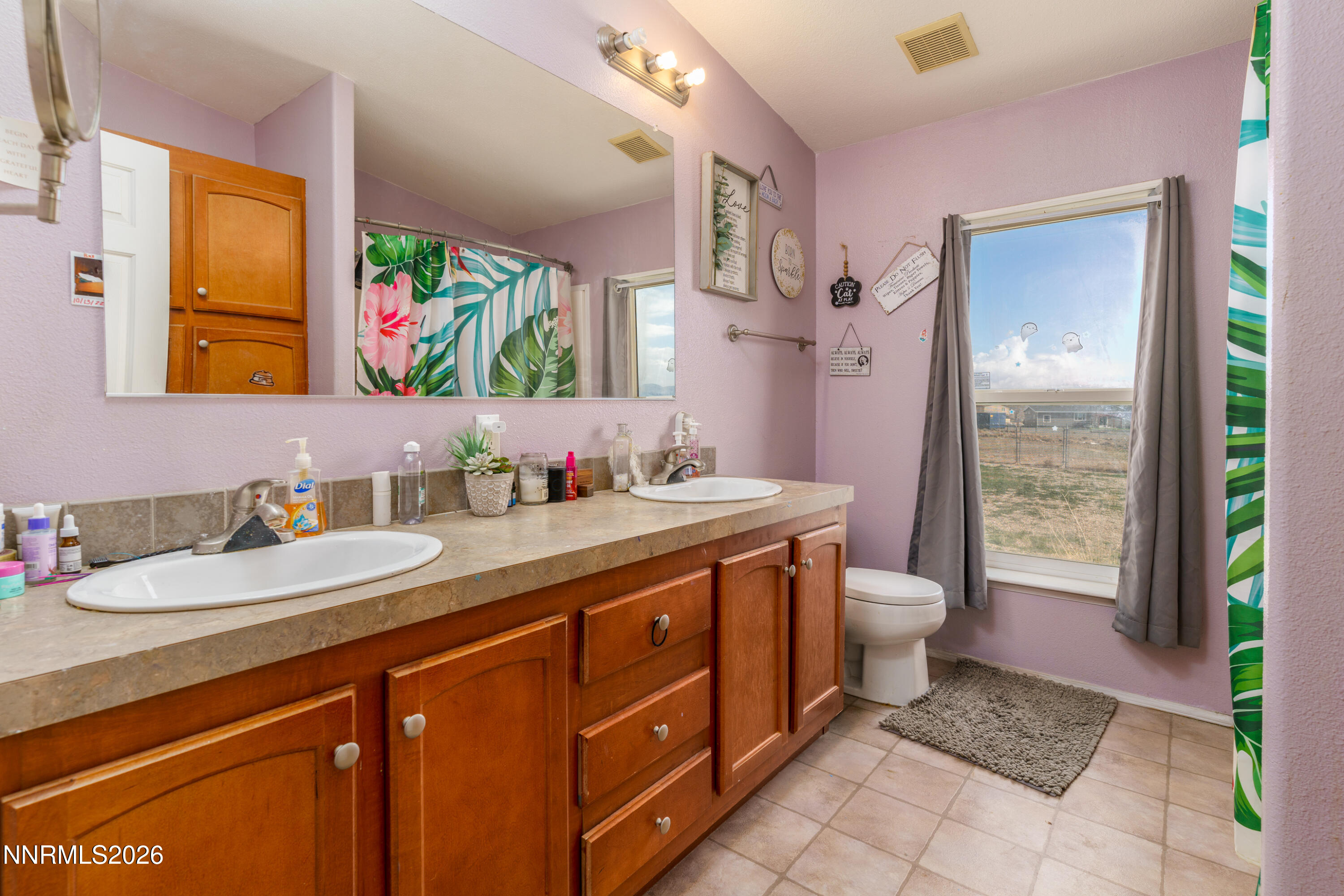 222 Julie Way Dayton, NV 89403 - Photo 18 of 28 a spacious bathroom with a granite countertop sink mirror and a toilet