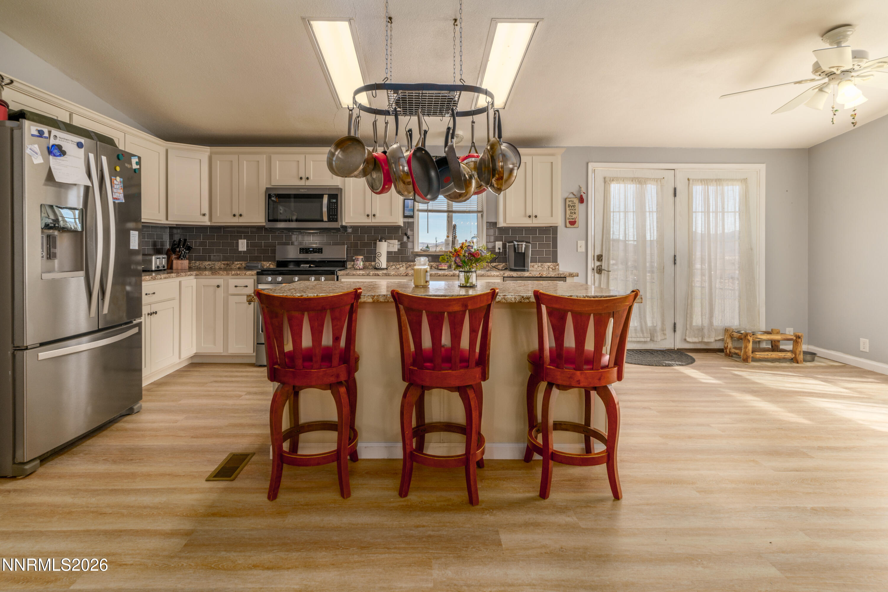 222 Julie Way Dayton, NV 89403 - Photo 9 of 28 a dining room filled with stainless steel appliances kitchen island granite countertop a table chairs and a refrigerator