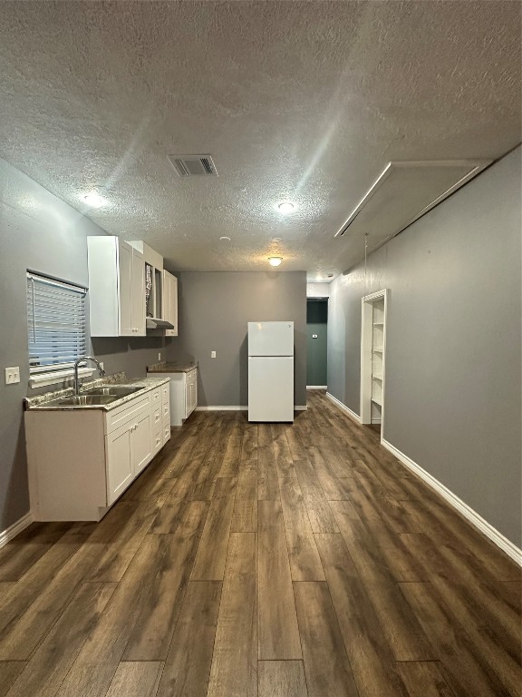 a large white kitchen with a stove a sink and dishwasher