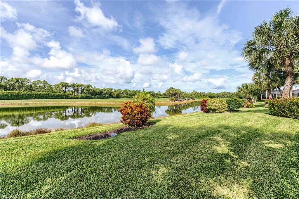 9156 Spring Run Boulevard Estero, FL 34135 - Photo 30 of 34 a view of a lake with houses in the back
