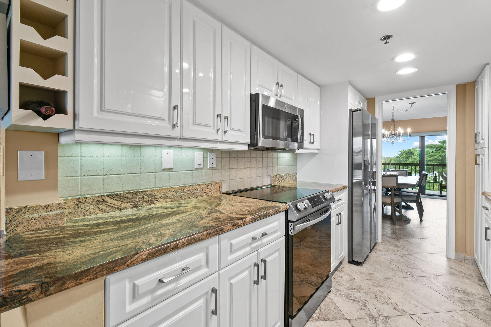 364 Golfview Road, Unit 506 North Palm Beach, FL 33408 - Photo 17 of 44 a kitchen with granite countertop a sink stove and cabinets