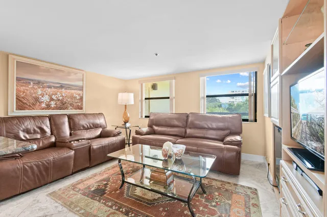 a living room with furniture wooden floor and a flat screen tv