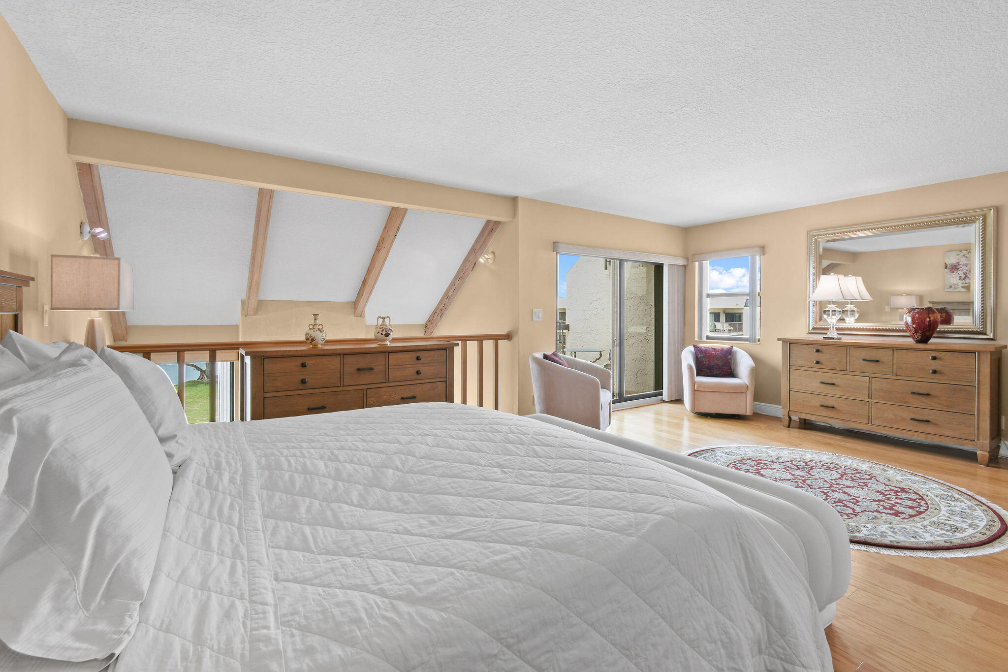 364 Golfview Road, Unit 506 North Palm Beach, FL 33408 - Photo 26 of 44 a spacious bedroom with a bed a dresser and large windows