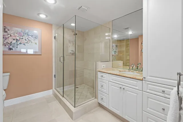 a bathroom with a shower sink and mirror
