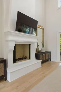 a kitchen with a stove a table and chairs in it