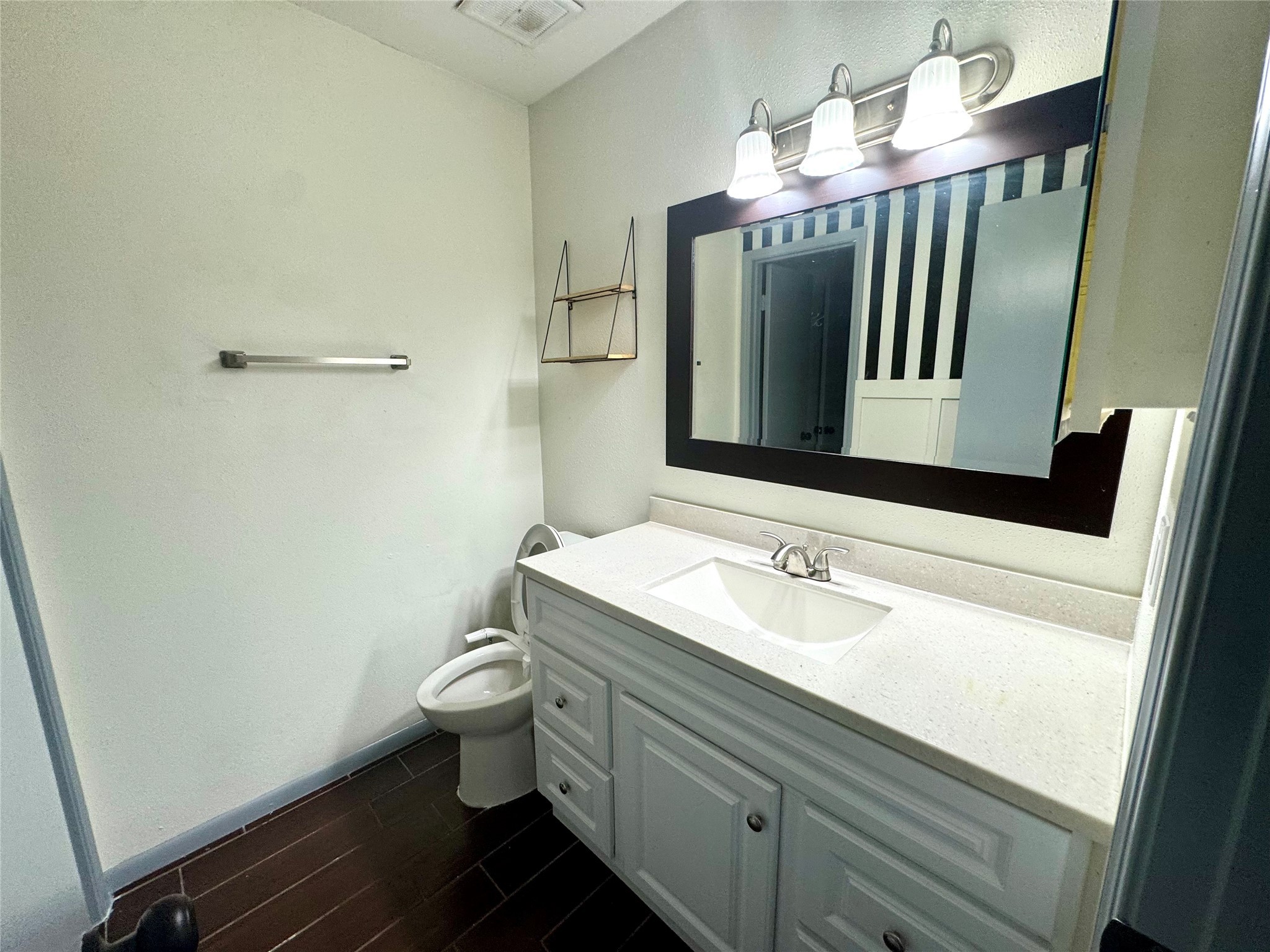 10010 Knoboak Drive, Unit 32 Houston, TX 77080 - Photo 13 of 17 a bathroom with a sink a toilet and mirror