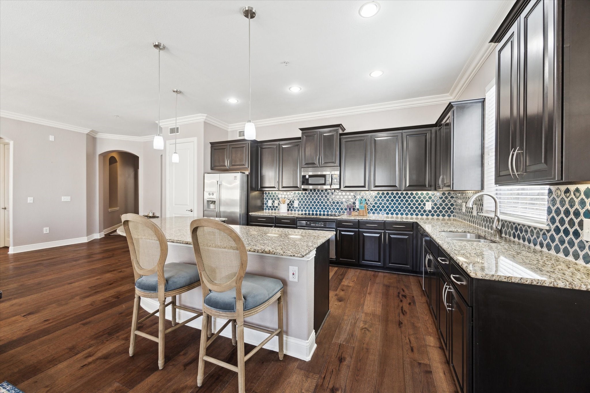 2120 Kipling Street, Unit 304 Houston, TX 77098 - Photo 6 of 21 a kitchen with stainless steel appliances granite countertop a kitchen island hardwood floor sink and stove
