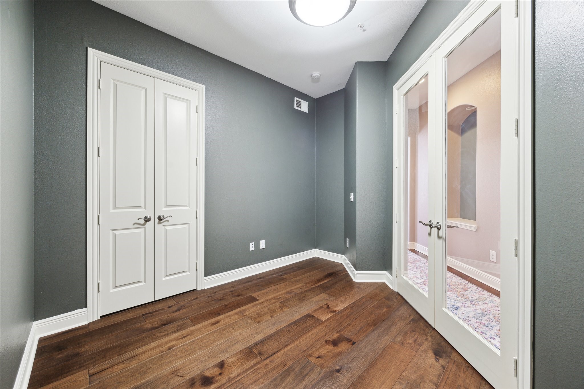 2120 Kipling Street, Unit 304 Houston, TX 77098 - Photo 10 of 21 a view of a hallway with wooden floor and a bathroom