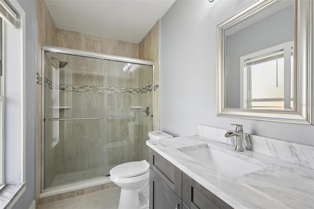 1978 Applegate Drive Ocoee, FL 34761 - Photo 11 of 50 a bathroom with a granite countertop sink toilet and shower