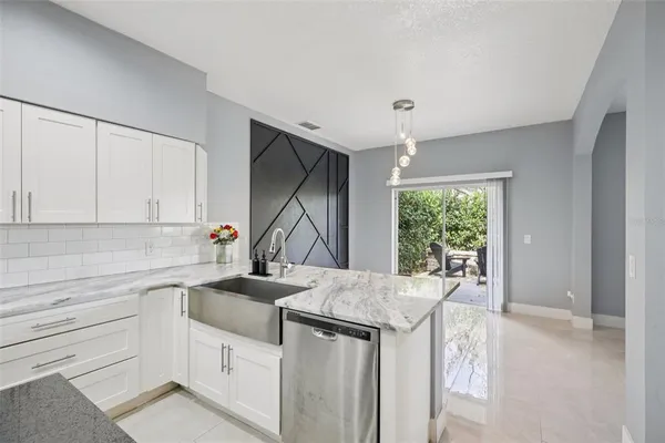 a front view of a house with a yard and potted plants