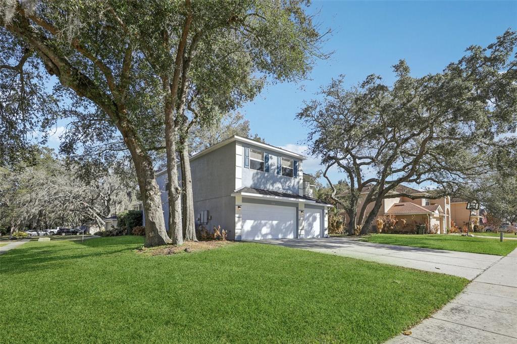 1978 Applegate Drive Ocoee, FL 34761 - Photo 4 of 50 a front view of a house with garden and trees