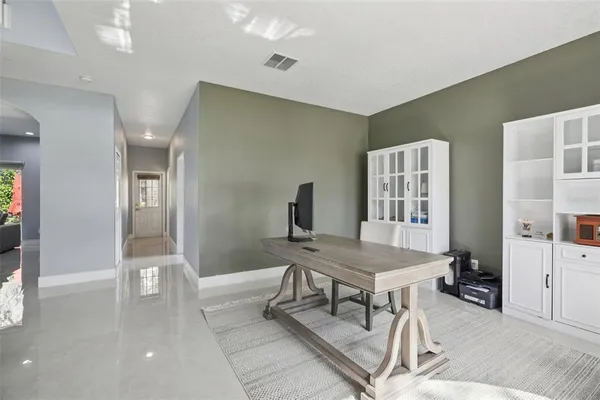 a bathroom with a tub shower and view of bathroom