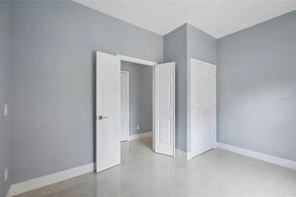 a bedroom with two beds and a couch