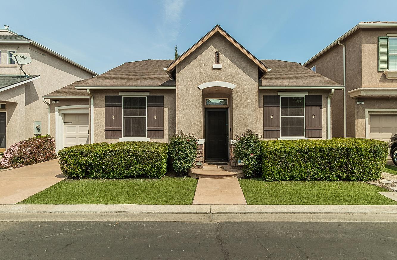 735 West Brittany Lane Clovis, CA 93619 - Photo 1 of 30 a front view of a house with a yard and garage