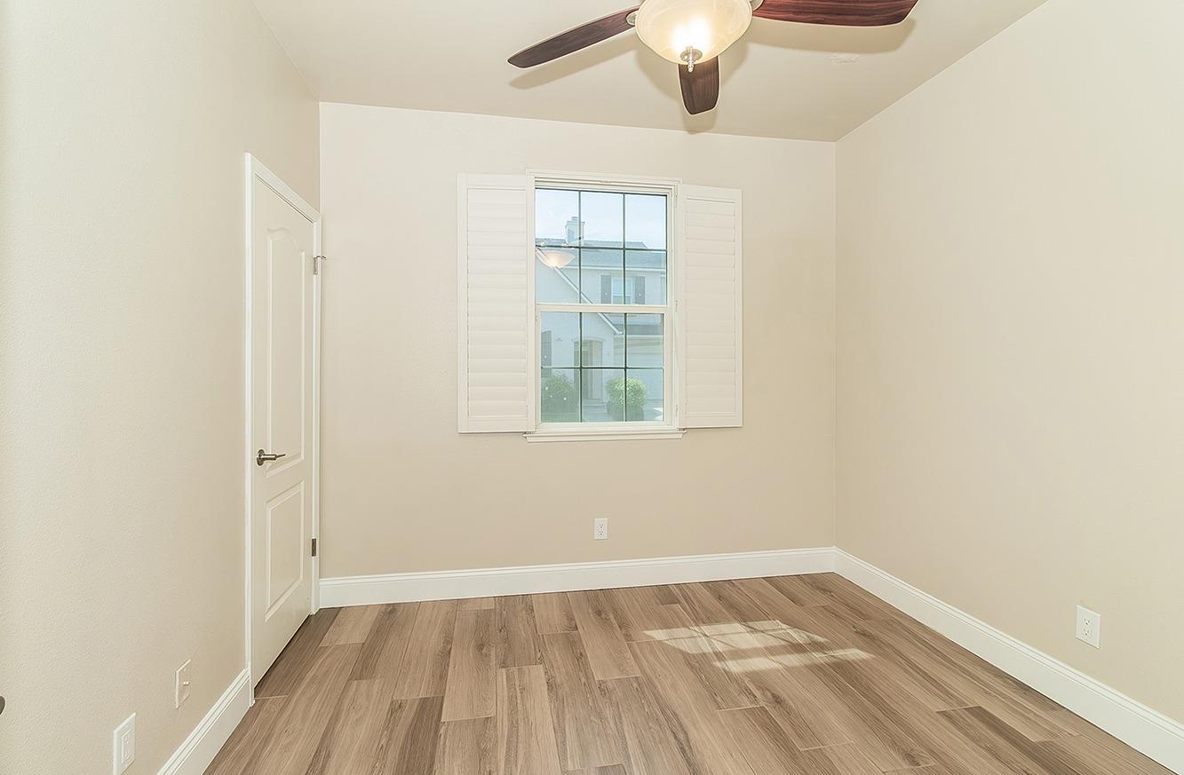 735 West Brittany Lane Clovis, CA 93619 - Photo 17 of 30 an empty room with a window and wooden floor
