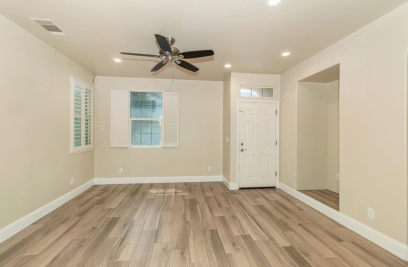 735 West Brittany Lane Clovis, CA 93619 - Photo 2 of 30 wooden floor in an empty room with a window