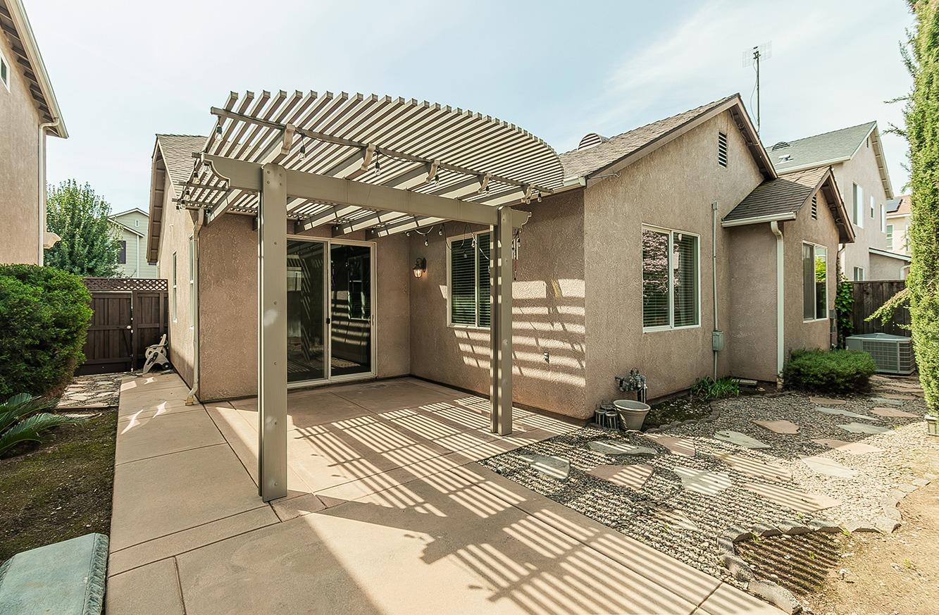 735 West Brittany Lane Clovis, CA 93619 - Photo 24 of 30 a view of a house with a door and chair