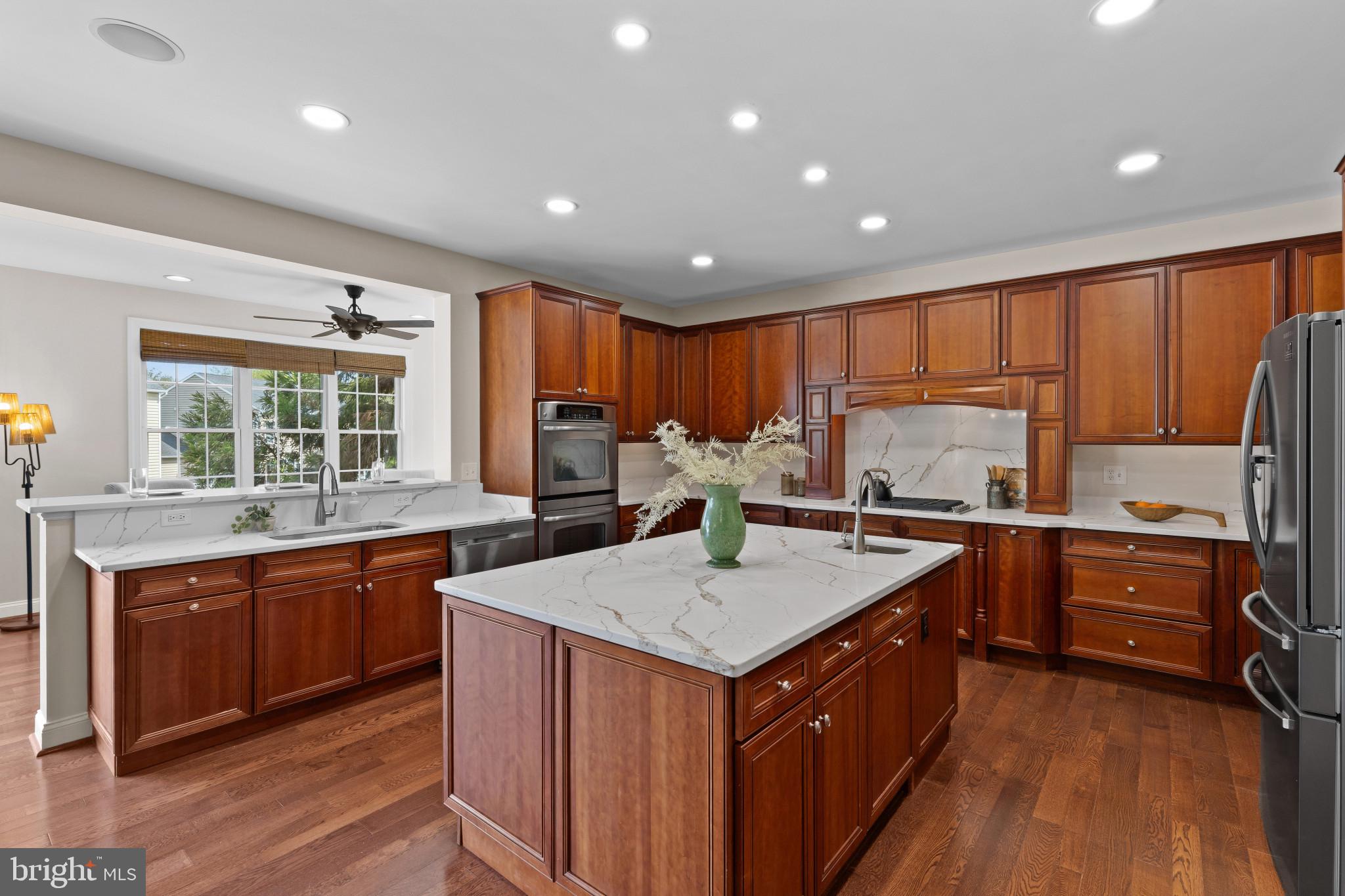 10725 Taylor Farm Road Woodstock, MD 21163 - Photo 14 of 70 a kitchen with stainless steel appliances granite countertop refrigerator sink and wooden cabinets
