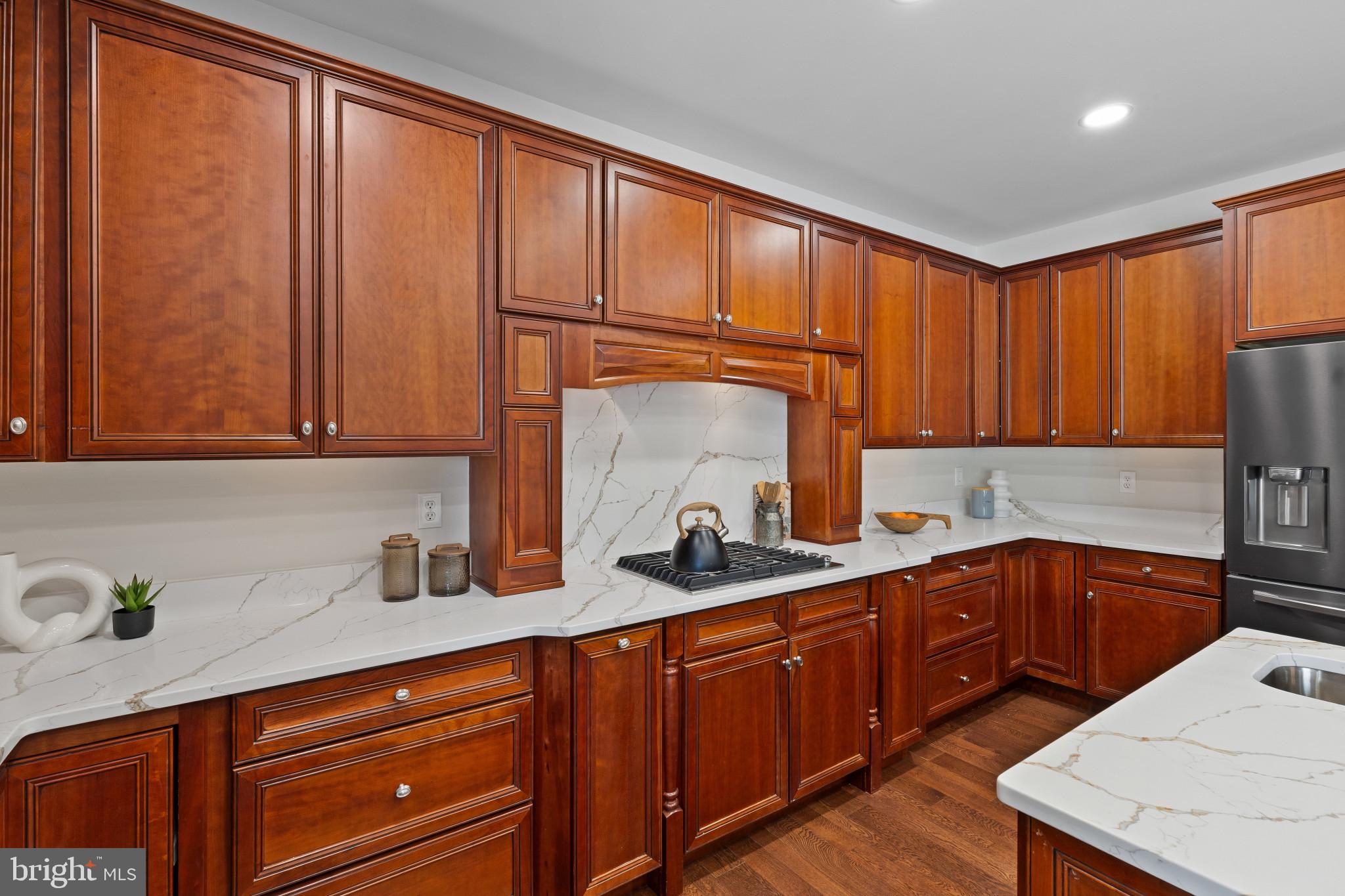 10725 Taylor Farm Road Woodstock, MD 21163 - Photo 15 of 70 a kitchen with stainless steel appliances granite countertop wooden cabinets a sink and a counter space