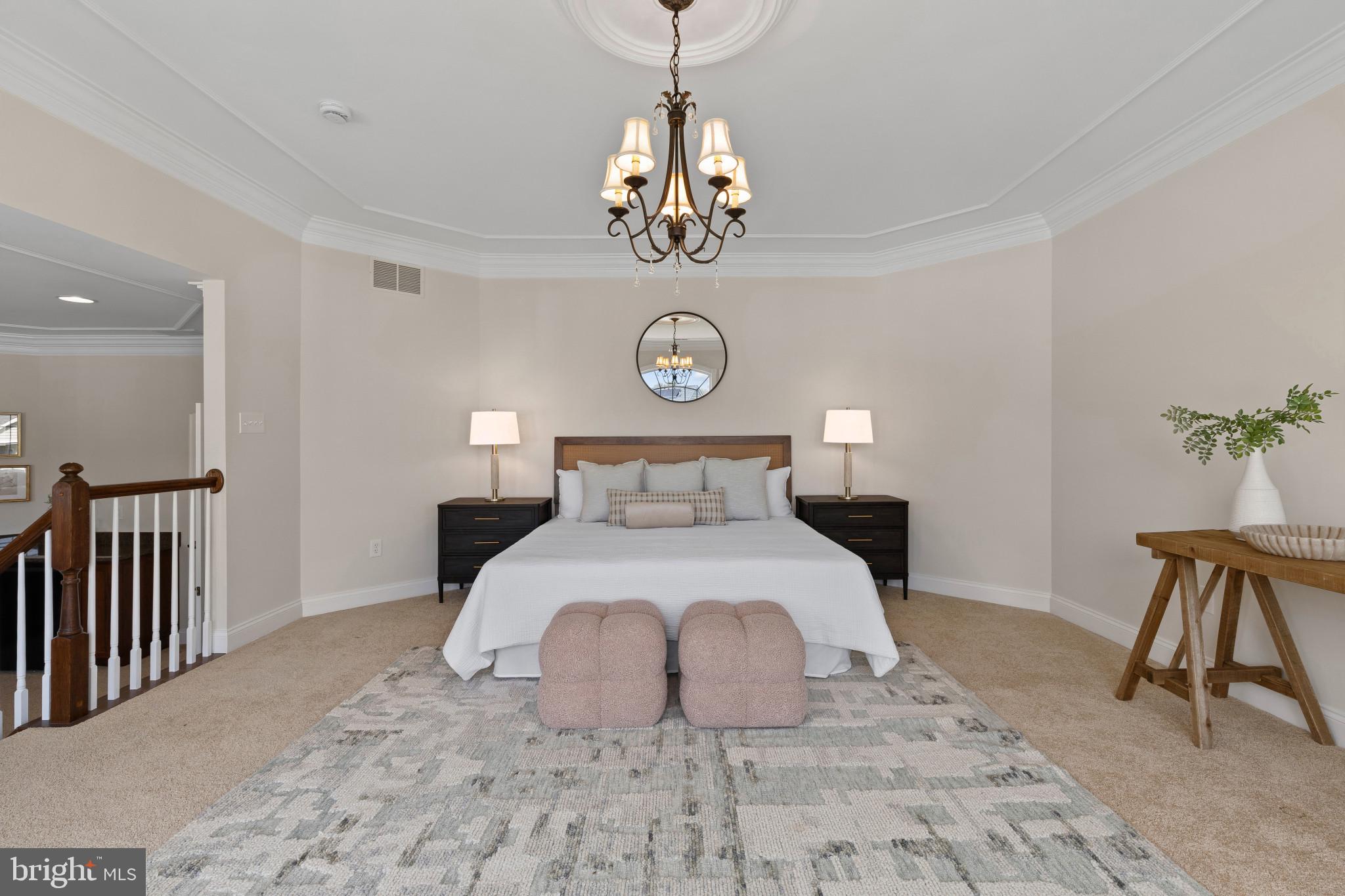 10725 Taylor Farm Road Woodstock, MD 21163 - Photo 26 of 70 a bedroom with a large bed and a chandelier