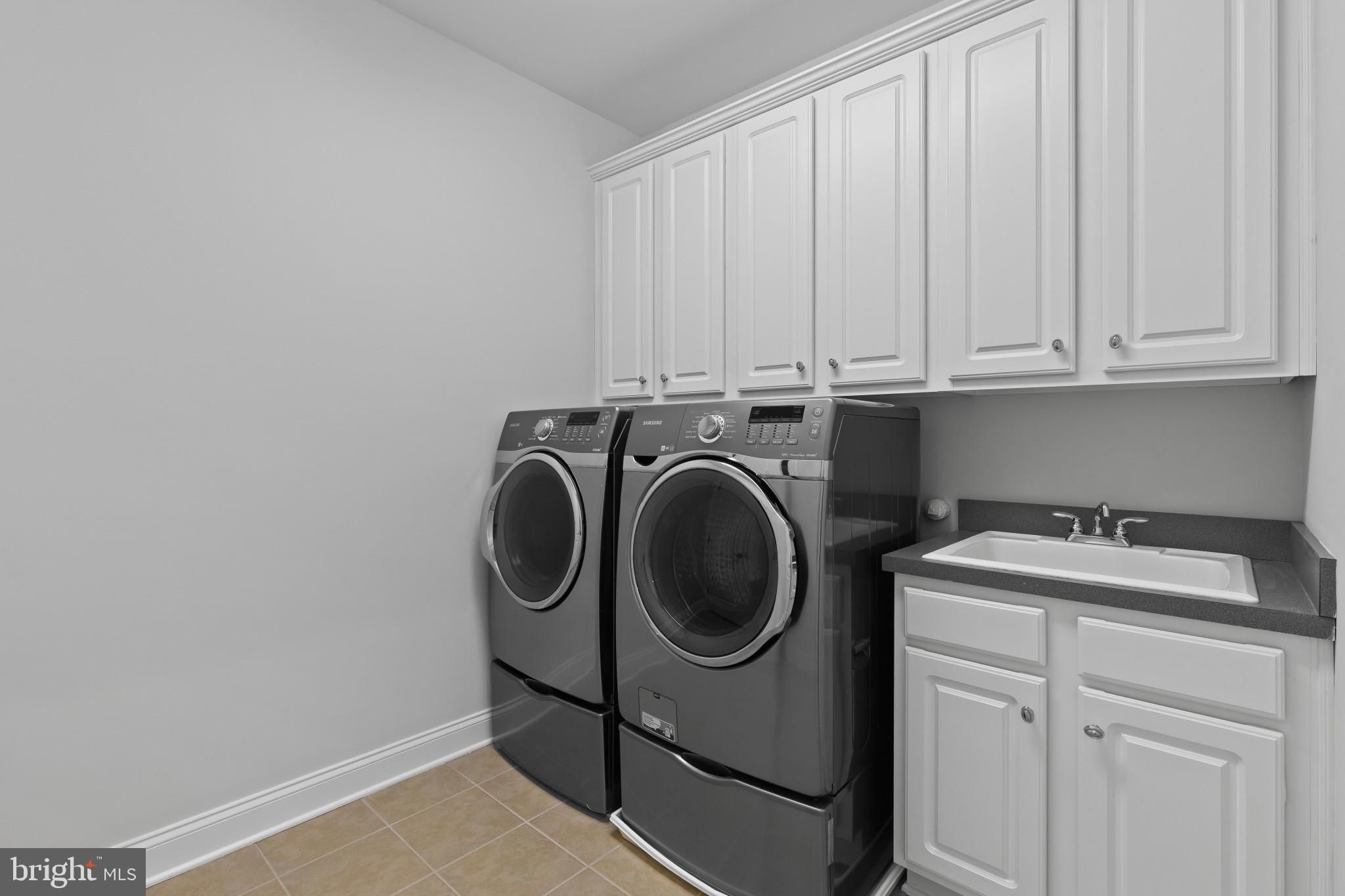 10725 Taylor Farm Road Woodstock, MD 21163 - Photo 44 of 70 a utility room with sink dryer and washer