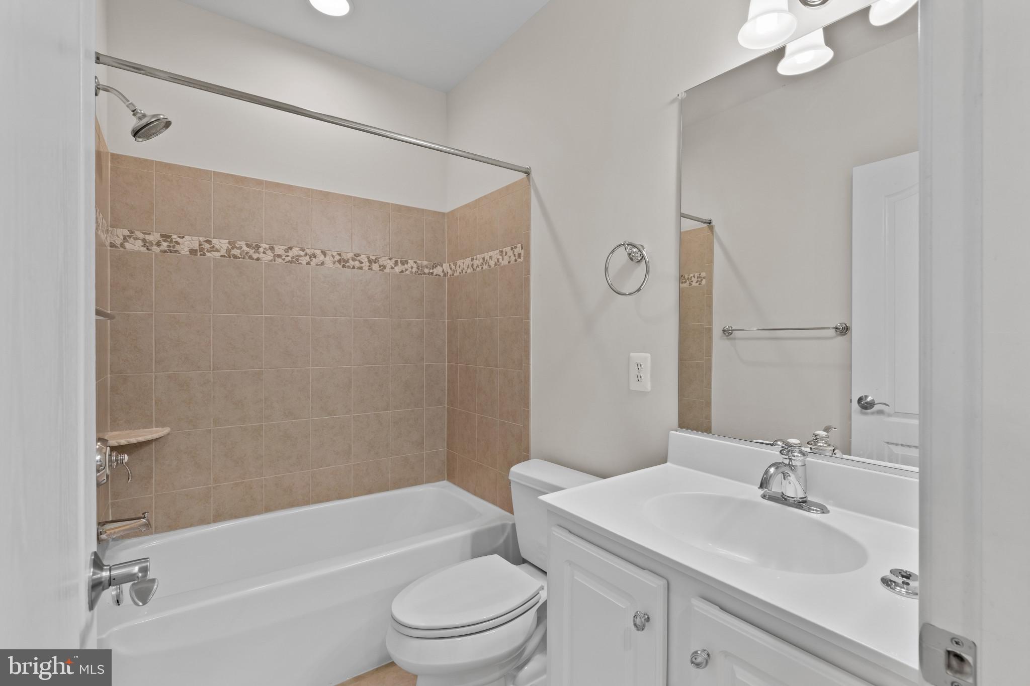 10725 Taylor Farm Road Woodstock, MD 21163 - Photo 51 of 70 a bathroom with a bathtub shower sink vanity mirror and toilet