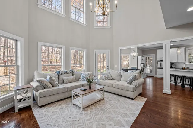 a living room with furniture or couches and a dining table with wooden floor
