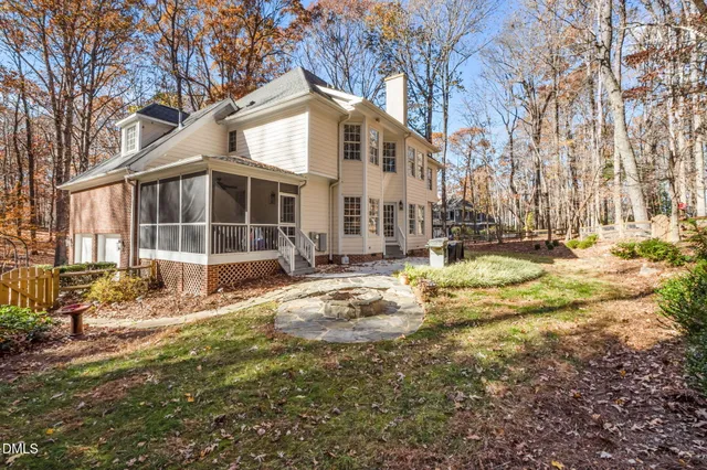 a view of a white house with large windows next to a road