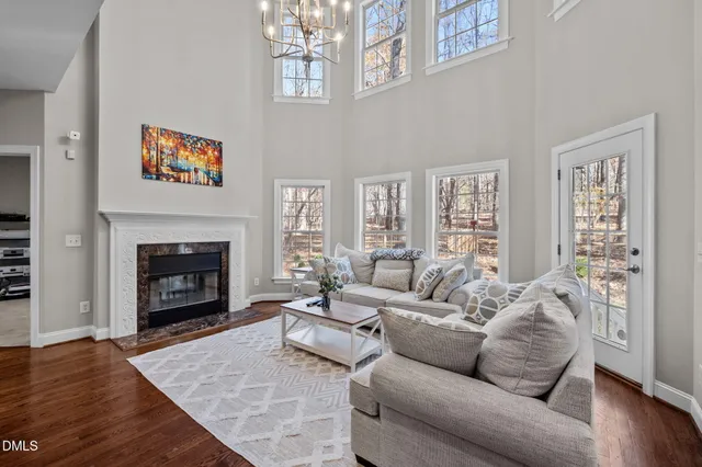 a living room with furniture a large window and a fireplace