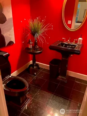 a kitchen with granite countertop white cabinets and sink