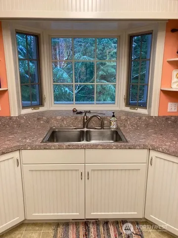 a stove top oven sitting inside of a kitchen