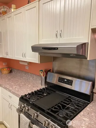 a kitchen with a table chairs and a sink