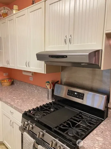 a kitchen with a table chairs and a sink