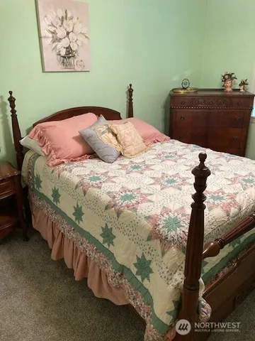 a bathroom with a granite countertop sink a toilet and mirror