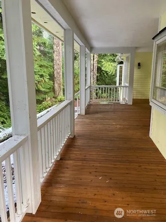 a view of a room with wooden floor and windows