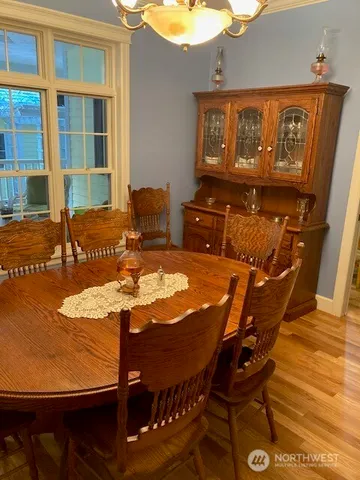 a view of a patio with table and chairs with wooden floor and fence