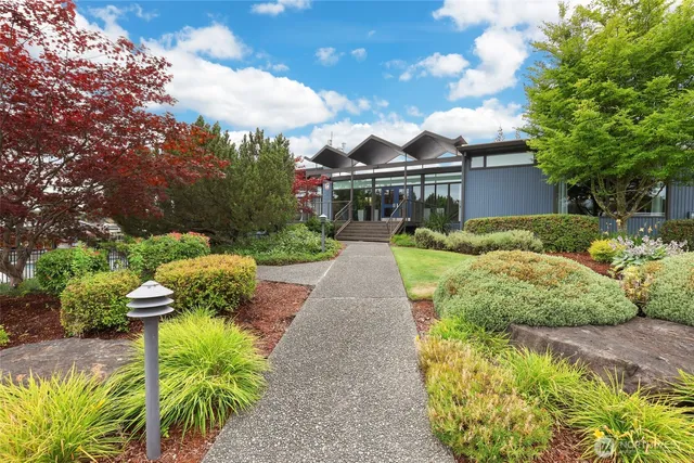 a front view of a house with a yard and fountain