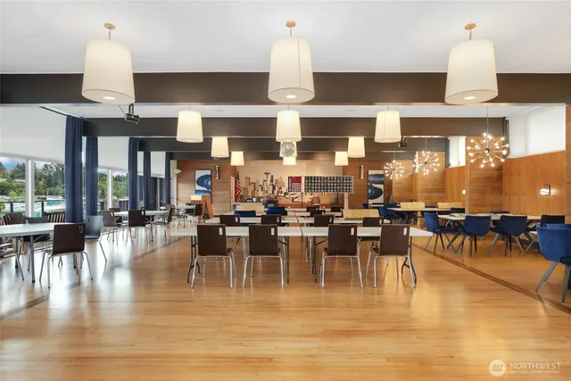 a dining room with lots of furniture and wooden floor
