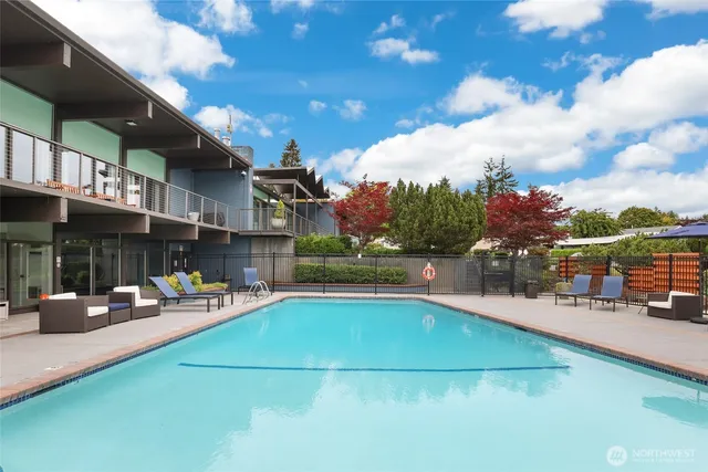 a view of a swimming pool with sitting area