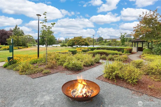 a view of a swimming pool with a yard and lake view in back