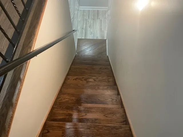 a view of an empty room and wooden floor