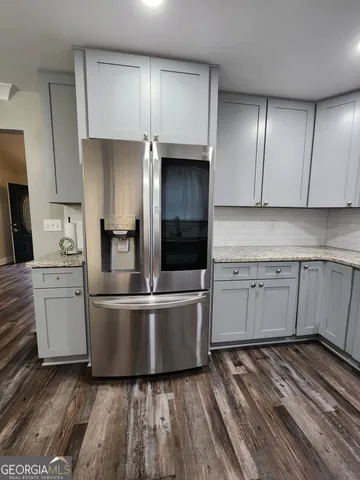 a kitchen with cabinets and wooden floor