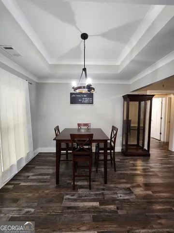a view of a dining room with furniture window and wooden floor
